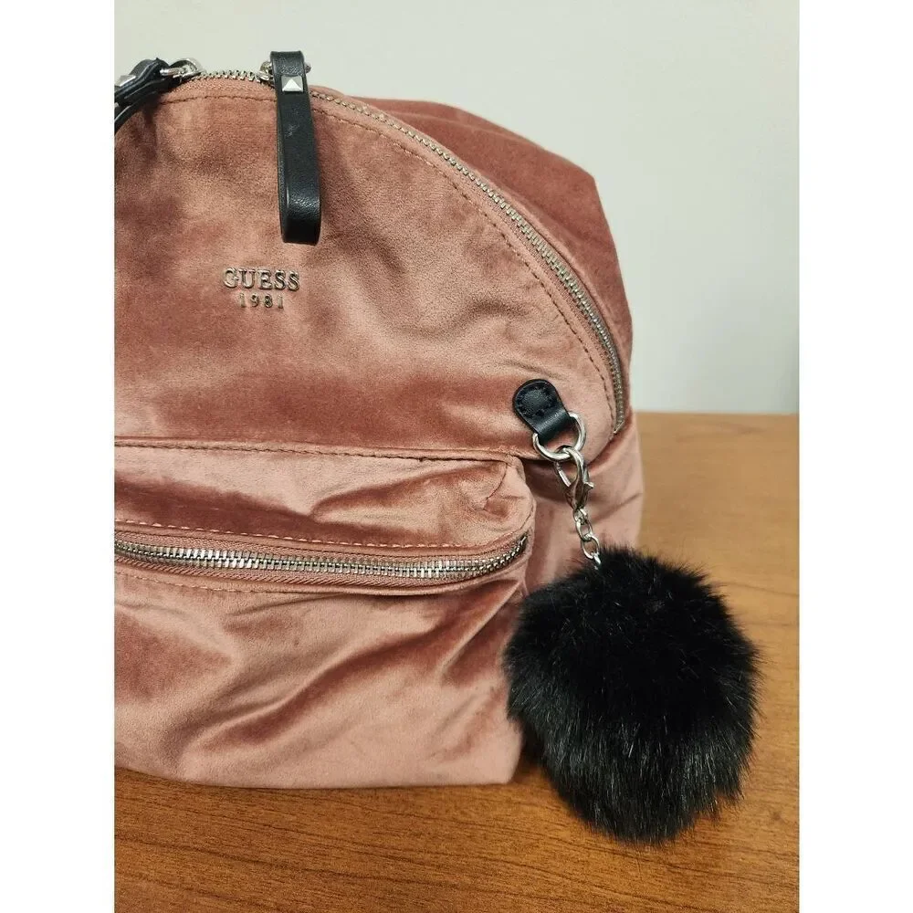 Guess small velvet feel pink backpack with black straps and pom. Measures approx